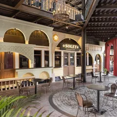We designed the Soley European Cafe in Bangalore to be a journey through history and modern design. The facade recreates the charm of an Italian streetscape, complete with a vintage tram car entrance and architectural ruins. This commercial project shows how we translate a brand's story into a memorable physical experience for customers.