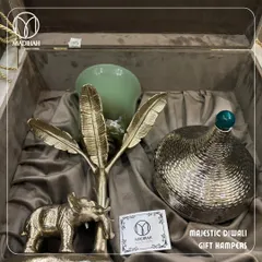 Another angle of the Majestic Diwali Hamper, showing the beautiful textures and materials. The combination of the glass hurricane, metal elephant, and lidded jar makes for a truly impressive gift.