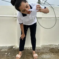 A student correctly positioned for Jala Neti. Proper posture is important to ensure the saline solution flows correctly through the nasal passages for a thorough cleanse.