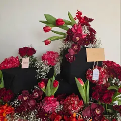 A wider view of the stunning red floral gift arrangement for Neetu Singh Kapoor, showing the scale and artistry of the composition.