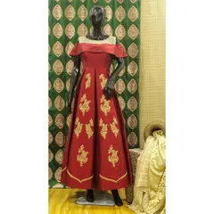 I designed this floor-length fusion gown in a rich red, featuring an elegant off-the-shoulder neckline. The skirt is adorned with delicate gold embroidery, adding a touch of traditional craftsmanship to a contemporary anarkali-style silhouette.