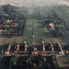 The beauty of architecture is often in its symmetry, something you can only truly appreciate from above. This top-down drone shot captures the incredible scale and design of this building surrounded by nature.