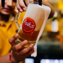 Capturing the perfect pour is all about timing and energy. This dynamic shot for Folks brewpub freezes the moment, showing the rich texture and head of the craft beer, making you feel like you're right there at the bar.