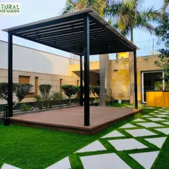 Another view of the Dwarka landscape, showing the clean lines of the pergola and the custom-designed stepping stone path.