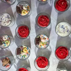 Bulk orders brightened so many celebrations this year. This image shows a variety of shot glass candles, including rose, teddy, and chocolate themes, ready for a large order.