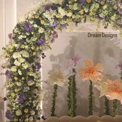 Another view of the baby shower backdrop, showing how the elegant sofa fits perfectly within the floral arch. This creates a comfortable and beautiful throne for the guest of honor.