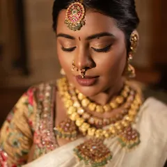 A close-up of the eye makeup, showing the soft, shimmery tones and perfectly groomed brows.