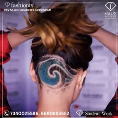 We push creative boundaries in our hair courses. This student's work features an intricate undercut with a vibrant blue wave design, showcasing advanced clipper techniques and creative hair coloring skills.