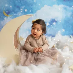 A quiet, curious look from the same moon-and-stars themed shoot. This setup is one of my most popular for sitter and toddler sessions.
