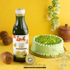 This image pairs a kiwi-flavored drink with a matching kiwi cake. This cross-promotional styling helps showcase how different products from a brand can be enjoyed together.