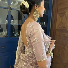 This is a classic gajra bun, a timeless choice for traditional events. The fragrant flowers are woven around a neat bun, creating a look of pure grace and sophistication.