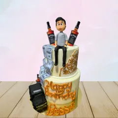 A two-tiered cake for the "Boss," featuring edible money, a miniature car, and bottles of Jack Daniel's. It's a fun and extravagant cake for a big celebration.