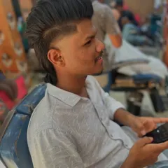This angle shows how the mullet style is constructed, with a high fade, a hard part for definition, and textured length at the back.