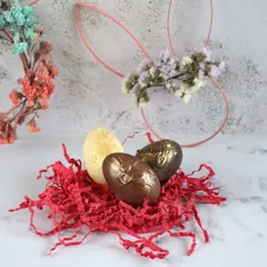 I craft these beautiful chocolate Easter eggs by hand. This nest features solid milk, dark, and white chocolate eggs with an elegant design, perfect for Easter baskets.