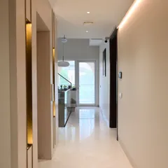 This hallway demonstrates our attention to detail. Notice the discreetly placed ceiling camera and wall-mounted control panel, providing security and control while blending perfectly with the home's warm, modern interior.