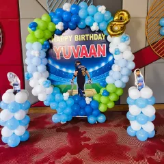 For a young cricket fan's 8th birthday, I designed this dynamic backdrop featuring their favourite player. The circular balloon arch in team colours and cricket-themed cutouts created an exciting atmosphere for Yuvaan's party.