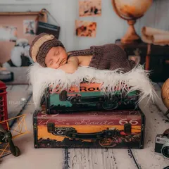 Another angle of the traveler theme, this time including a vintage camera prop. It highlights the level of detail and creativity I bring to my newborn photography sessions in Mumbai.