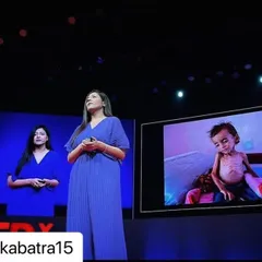 The final result on stage at a major conference. This demonstrates how my makeup and hair styling translates in a real-world public speaking environment, ensuring the speaker looks composed and professional throughout their presentation.