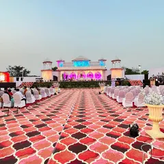 I build dream wedding stages, like this expansive 'Rajwada' setup. The design features a pristine white palace facade, complete with domes and archways, creating a timeless and elegant backdrop for the main ceremony.