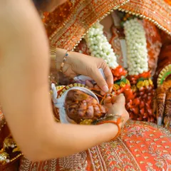 A close-up of a ritual during the wedding ceremony, highlighting the intricate details and traditions.