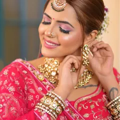 A beautiful shot of a bride adjusting her earring, giving a clear view of the intricate kundan work on her rental jewellery.
