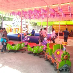 A view of the mini train set up under a tent at a carnival-style event. It's a reliable attraction that keeps young children entertained.