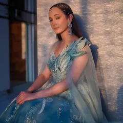 The same ombre gown captured in the golden hour light. The delicate, leaf-like shoulder detail and the sparkling fabric make this a truly unique piece for a reception or pre-wedding shoot.
