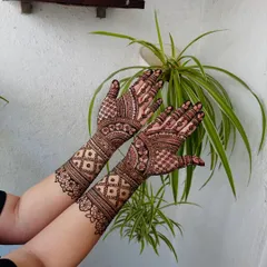 This is a beautiful example of symmetrical design work, where both hands mirror each other with elaborate floral and geometric patterns for a harmonious finish.