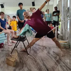 Here, I demonstrate Utthita Trikonasana (Triangle Pose) using a chair and ropes. This showcases the Iyengar method's use of props to achieve precise alignment and a deeper understanding of the asana's mechanics.