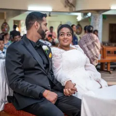 A candid glance shared between the bride and groom during their Catholic wedding ceremony. These small, unscripted interactions are what make your wedding story unique.