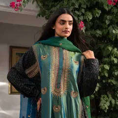 A rich, jewel-toned salwar kameez in green and black. The intricate embroidery and contrasting dupatta make this a perfect outfit for a Mehendi or a festive family dinner.