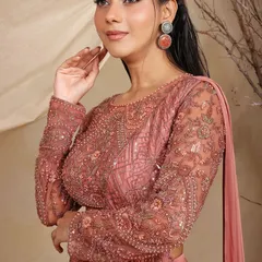 A closer look at the exquisite hand-embroidery on our rose-dust lehenga-saree. The sheer sleeves and intricate sequin work add a layer of sophistication and artistry.