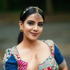 A close-up portrait that brings attention to the model's expression and the detailed embroidery on the blouse. This shot is ideal for social media features.
