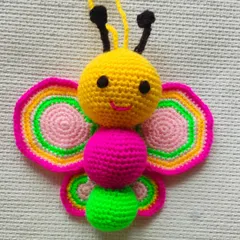 A very cute and colorful crochet butterfly. I used bright yellow, pink, and green yarn to make it. This can be a toy or even a decoration for a child's room.