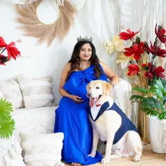 A beautiful family portrait with a very well-behaved dog. This image perfectly captures the love and excitement of the entire family, paws and all.