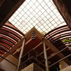 Let there be light. A view looking directly up into a glass-block skylight, which diffuses sunlight and casts a gentle glow over the space below. The geometric grid of the skylight contrasts with the curved architectural elements.