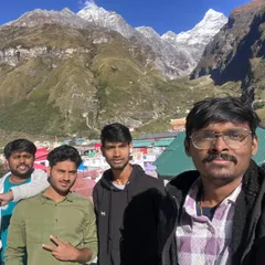 A group of friends taking a selfie at Badrinath, with the Neelkanth peak in the background. Our Do Dham and Char Dham packages ensure you experience the divinity of every holy site.