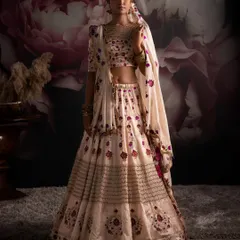Discover the charm of the season through my interpretation of nature's elegance. This exquisite bridal lehenga, with its intricate floral embroidery, invites you to envelop yourself in grace.