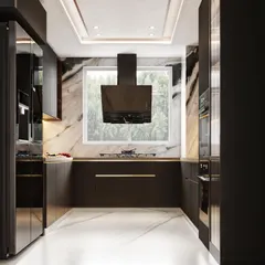 This view of the charcoal grey kitchen focuses on the cooking area, showing the chimney hood set against a large window and the seamless countertop.