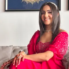 A candid shot of the client looking happy and confident in her full glam look.