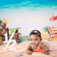 A beach-themed half-birthday is a fun way to mark six months. This little one is enjoying tummy time on our studio "sand."