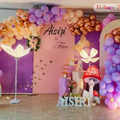 A whimsical enchanted forest theme for Aisiri's fifth birthday. I used a color palette of purple, peach, and rose gold, with glowing mushroom props and butterfly accents.