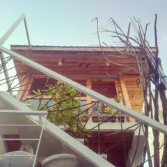 Another view of the studio, looking up at the wooden cabin through the white metal staircase. It's a creative space designed to fuel creative work.