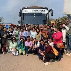 Our entire travel group posing in front of our bus before heading to the Kumbh grounds. We travel as a community, supporting each other on this incredible journey.