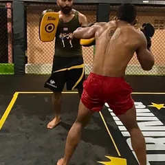 Holding pads is an art. I feel my student's rhythm, power, and technique, correcting them with every combination they throw.