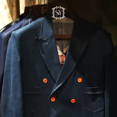 This double-breasted denim blazer with bright orange buttons is a perfect example of a modern, statement-making piece. It combines a classic silhouette with a playful, contemporary twist.