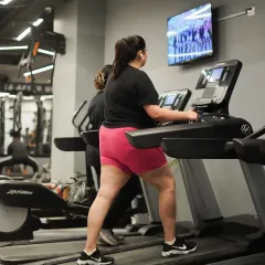 A member gets her cardio session in on the treadmill, a classic and effective way to improve cardiovascular health and burn calories.
