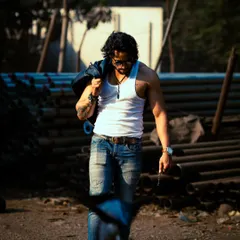 A powerful walking shot that conveys confidence and purpose. The lighting and composition give it a movie-still quality.
