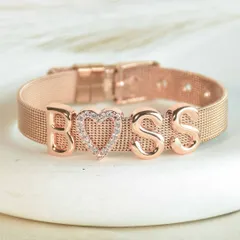 For the one in charge. The 'BOSS' bracelet, featuring a sparkling pavé heart charm on a rose gold mesh band, is a daily reminder of your power.