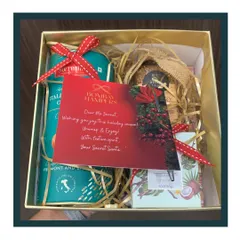 Spreading festive cheer with a Secret Santa hamper. This gift box is filled with cookies, treats, and a personalized card to make the holiday season special.